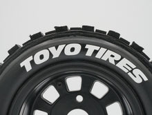Load image into Gallery viewer, Best rc car tire / wheel sticker decals on the market. Made to fit BRP tires. Includes (8) stickers: "Toyo Tires" Logo. Does not include BRP knobby tire. This vinyl is long-lasting, specially made for vehicles, and has permanent adhesive properties. Clear transfer tape is on top of the vinyl, to allow seamless transfer to your tires.  Refer to these dimensions to determine fitment: Stickers are 3/8 inch tall, and curved for a 4-1/4 inch diameter rim.