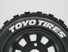 Load image into Gallery viewer, Best rc car tire / wheel sticker decals on the market. Made to fit BRP tires. Includes (8) stickers: &quot;Toyo Tires&quot; Logo. Does not include BRP knobby tire. This vinyl is long-lasting, specially made for vehicles, and has permanent adhesive properties. Clear transfer tape is on top of the vinyl, to allow seamless transfer to your tires.  Refer to these dimensions to determine fitment: Stickers are 3/8 inch tall, and curved for a 4-1/4 inch diameter rim.
